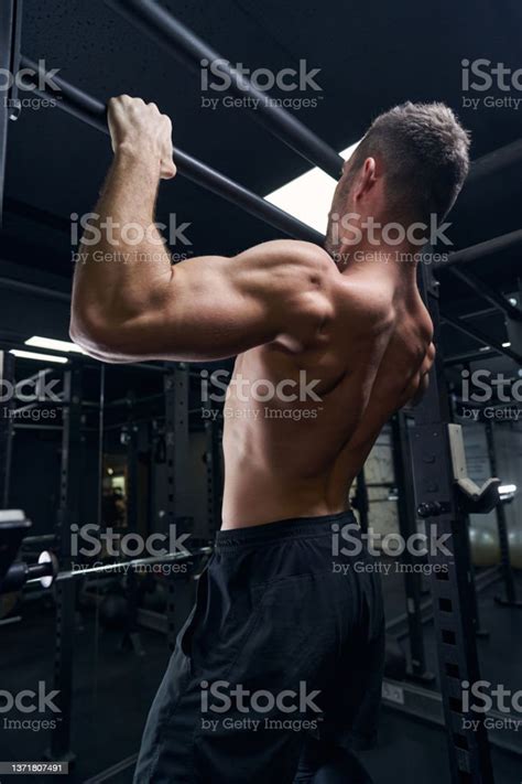 Strong Sportsman Demonstrating His Muscles During Training Stock Photo
