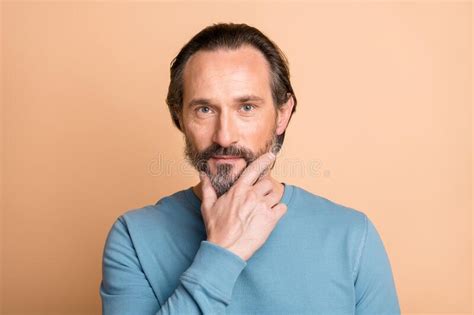 Photo Of Handsome Mature Guy Calm Face Finger Chin Wear Blue Pullover Isolated Beige Color