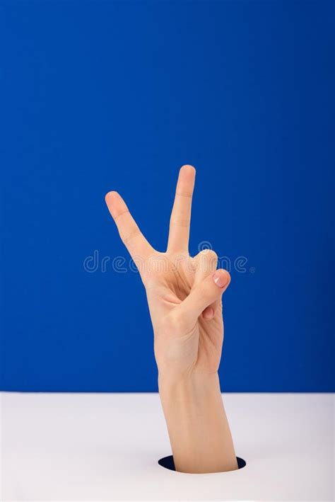 View Of Woman Showing Peace Sign Isolated On Blue Stock Image Image