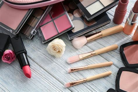 Set Of Decorative Cosmetics With Brushes On Wooden Table Stock Photo