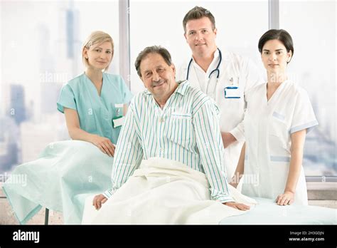 Older Patient On Bed With Hospital Crew Stock Photo Alamy