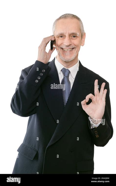 An Amiable Businessman Smiling On Mobile Phone And Showing The Okay