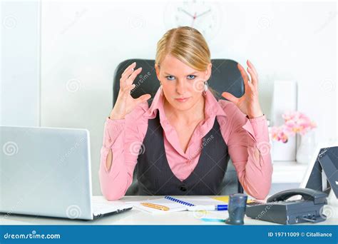 Angry Business Woman Sitting At Office Desk Stock Image 19711009