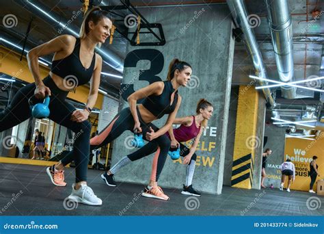 Crossfit Workout Three Young Strong Fitness Girls Exercising With Iron