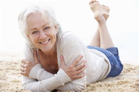 Senior Woman Relaxing On Beach Stock Photo Image Of Horizontal