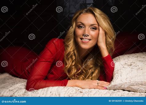 Sensual Blonde In A Red Dress Lying On The Bed Stock Image Image Of