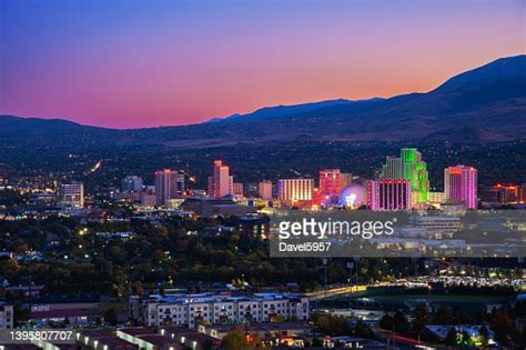Reno Skyline At Dusk With Illuminations And A Multicolored Sky High Res