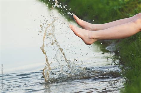 Feet Splashing Water From The Embankment Of A Water Ditch By Tana Teel