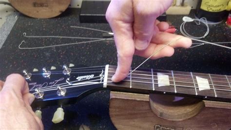 The New Nut In Place And Screw It In Place How To Replace A Guitars Nut Fuelrocks