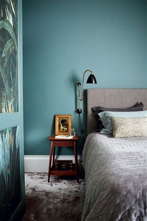 A Contemporary Teal Blue Bedroom With Grey Velvet Accessories In