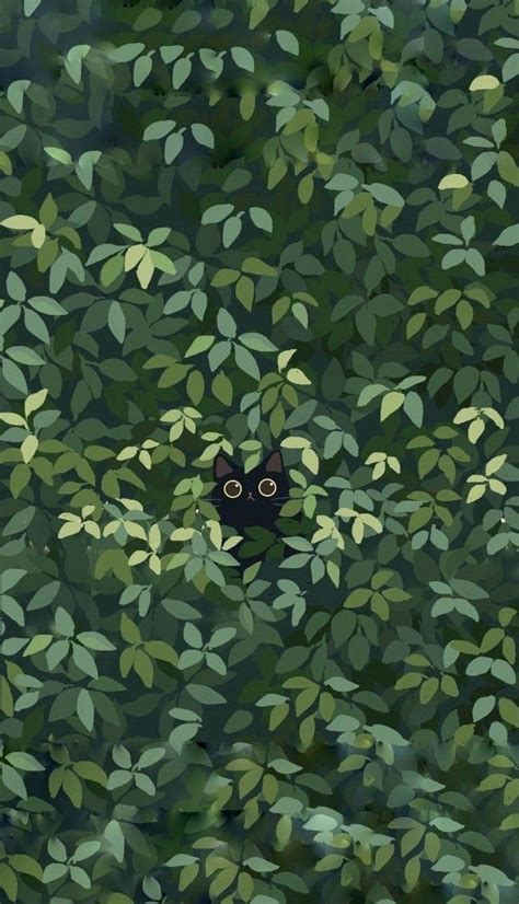 A Black Cat Peeking Out From The Leaves Of A Tree With Eyes Wide Open