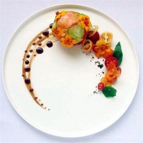 A White Plate Topped With An Appetizer Covered In Fruit And Vegetables