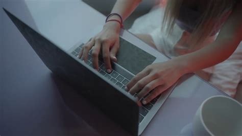 A Girl Sitting At Her Desk And Typing On Her Laptop Free Stock Video