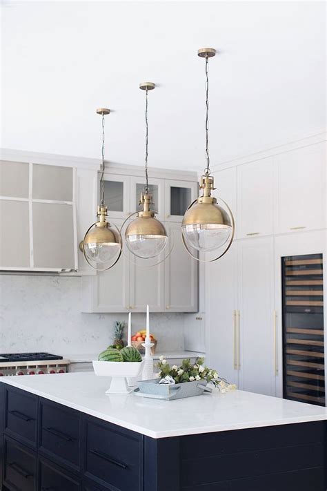 Taupe kitchen island, storage, and cabinets exude the elegance. Gold Hardware, White countertops, Kitchen Chandelier (With ...