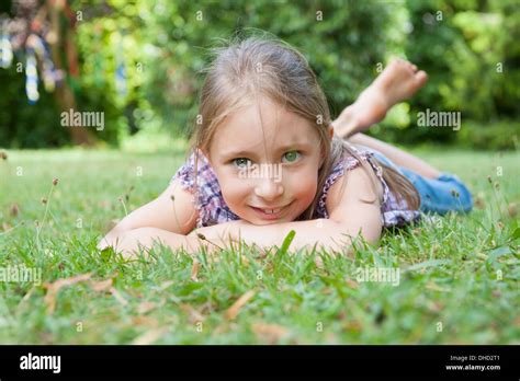 Smiling Girl Lying In Grass Stock Photo Alamy