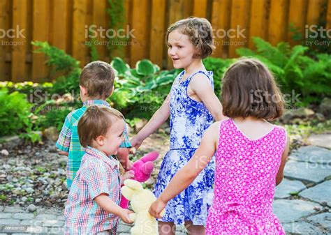 Children In A Circle Playing Ring Around The Rosie Stock Photo