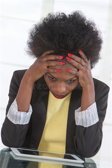 Portrait Of Mature Black Unhappy Business Woman At Desk In Office Stock