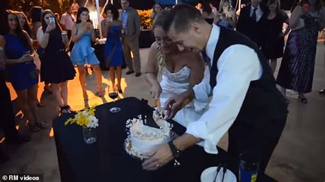 groom smashes wedding cake into bride s face and sends her falling to the ground daily mail online