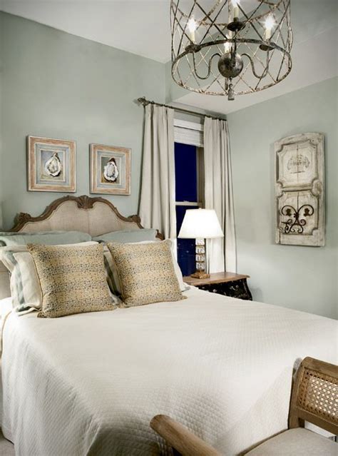 The Guest Room With Walls Painted A Silver Sage Color And Art