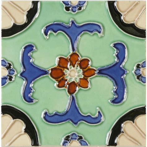 An Artistic Tile Design In Blue Green And Pink With Red Flowers On The