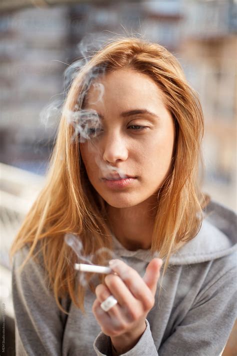 Attractive Young Woman Smoking Cigarette By Stocksy Contributor Mem