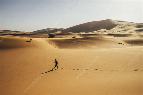 Man Walking In Desert Sahara Morocco Stock Image F0243039