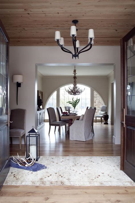 By hanging one of these foyer chandeliers in your entryway or reception area, guests can't help but be dazzled. Neutral Rustic Foyer With Black Chandelier | HGTV