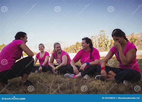 Female Trainer Instructing Women While Exercising In The Boot Camp