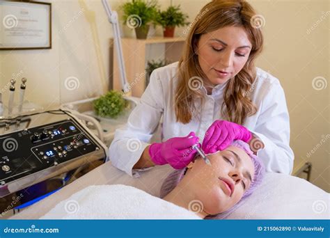 Beautician Makes Skin Care Procedure On A Face Cosmetologist Applying