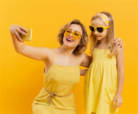Free Photo Happy Woman And Girl Taking A Selfie While Wearing Sunglasses