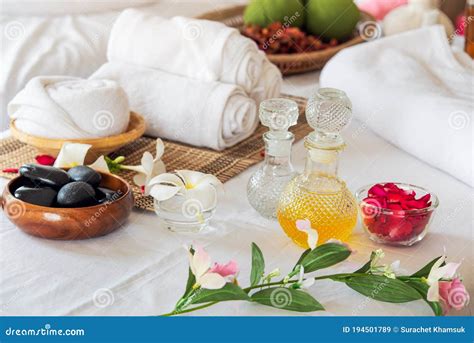 Spa Composition In Wellness Center Spa Treatment Set And Aromatic Massage Oil On Bed Massage