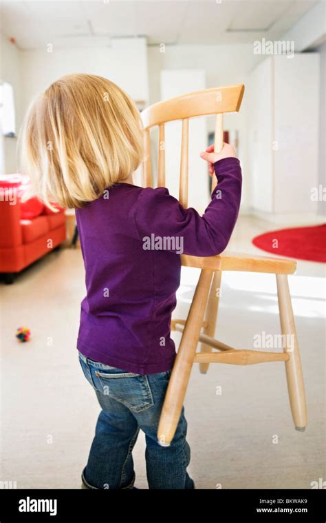 Girl Carrying Chair Stock Photo Alamy