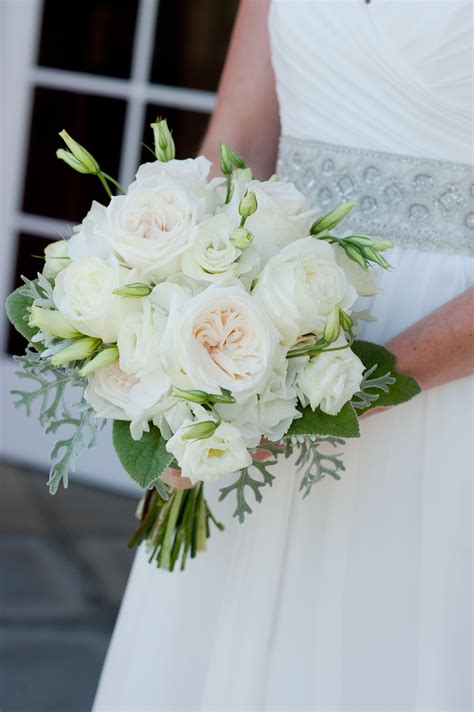 A Bridal Holding A Bouquet Of White Flowers