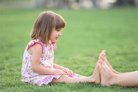 Babe Girl Measuring Her Tiny Feet With Her Older Babe By Stocksy Contributor Ibex Media