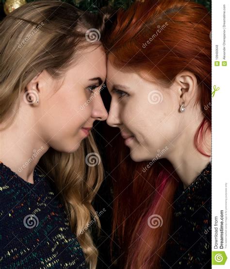 girlfriends spend time together two pretty lesbians girlfriends kissing and hugging in a cozy