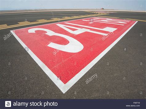 Directional Sign Markings On The Tarmac Of Runway At A Commercial
