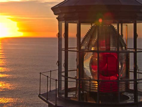 The Sun Setting Over The Pacific Ocean As A Once Active Light House