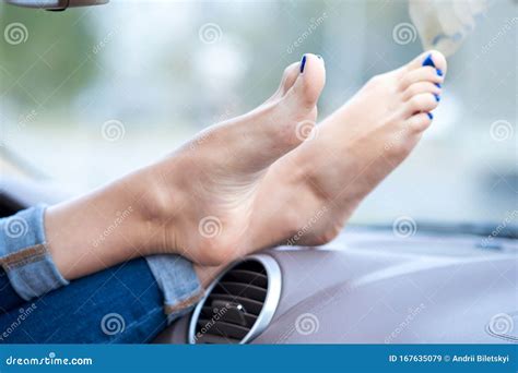 Close Up Of Woman Driver Feet Resting On Car Dashboard Stock Image