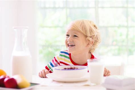 Child Eating Breakfast Kid With Milk And Cereal Stock Image Image Of