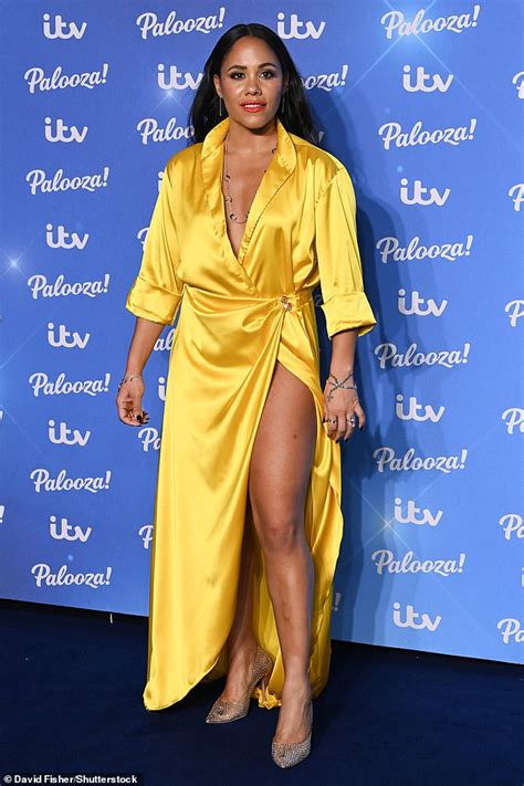 alex scott puts on a leggy display in an eye catching yellow satin wrap dress with daring thigh