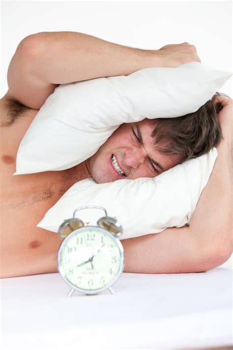 Angry Man Waking Up By His Alarm Clock Stock Photo Image Of Pillow
