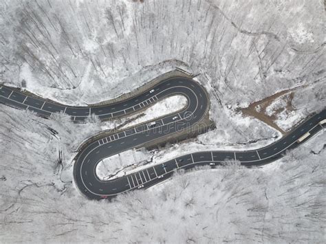 Beautiful Aerial View Of Winding Road Mountain Cutting Through Forest