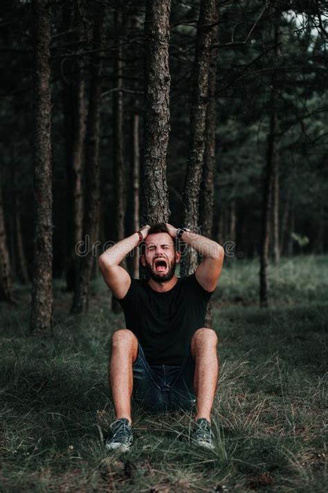 Young Depressed Man Sitting Alone In The Forest Stock Photo Image Of