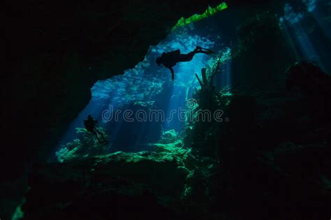 Divers Exploring Hidden Reefs In Underwater Cave Stock Image Image Of