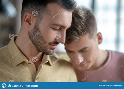 Two Men Standing Next To Each Other Feeling In Love Stock Photo Image