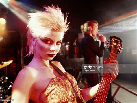 Woman Playing Electric Guitar On Stage Portrait High Res Stock Photo