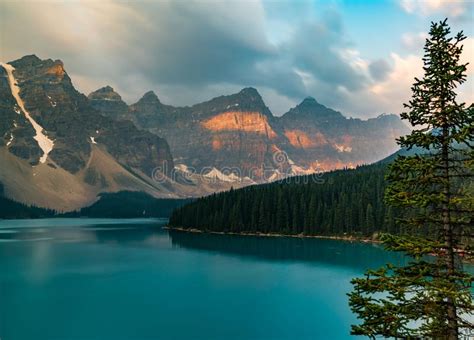 Sunrise With Turquoise Waters Of The Moraine Lake With Sin Lit Rocky