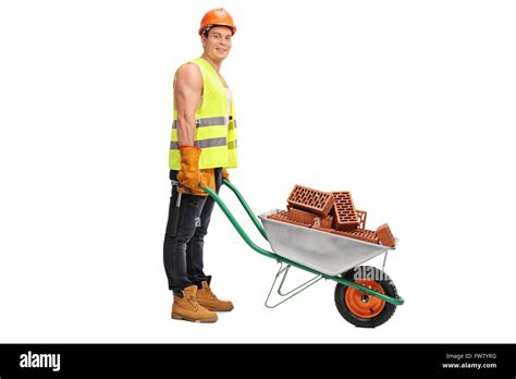 Construction Worker Posing With A Wheelbarrow Full Of Bricks Isolated