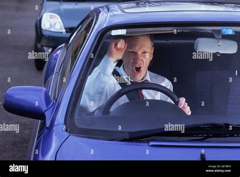 Businessman Stuck In Traffic Jam Showing Road Rage Uk Stock Photo Alamy