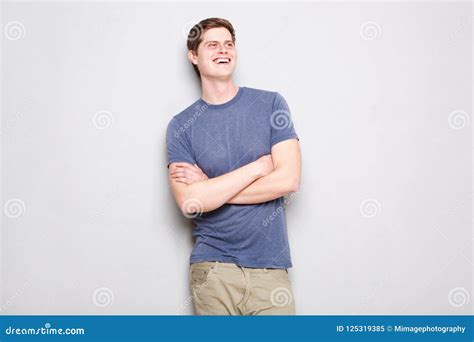 Happy Young Man Standing By Wall With Arms Crossed Stock Image Image